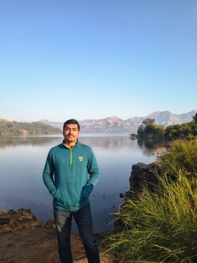 Mohit standing in front of Lake